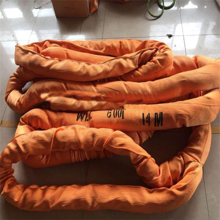 An orange sleeved round sling folded on a tiled floor with WLL 6T 14M printed in black along the cover