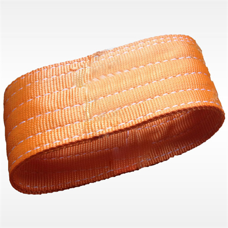 A flat woven band in a dyed orange colour with transverse stitching along its face, closed into a loop and photogr
aphed against a pale ground