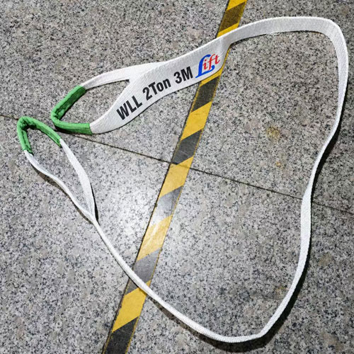 One way lifting sling with a white flat woven band, printed working load limit and green protective sleeving at the formed ends