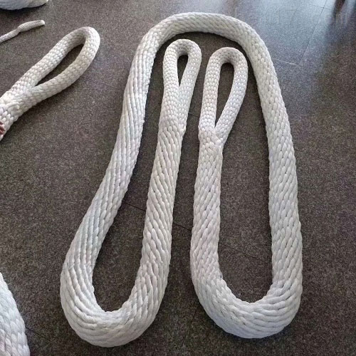 Two white braided ropes laid on a brown floor as long open loops, each turned back into itself so the structure con
tinues through the bend